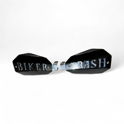 Motorcycle hand guards with the saying "Biker trash" cut into the black powder-coated outer shell bolted to a chrome powder coated mount.