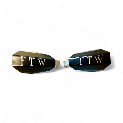Motorcycle hand guards with "FTW" cut into the black powder-coated outer shell bolted to a chrome powder coated mount.