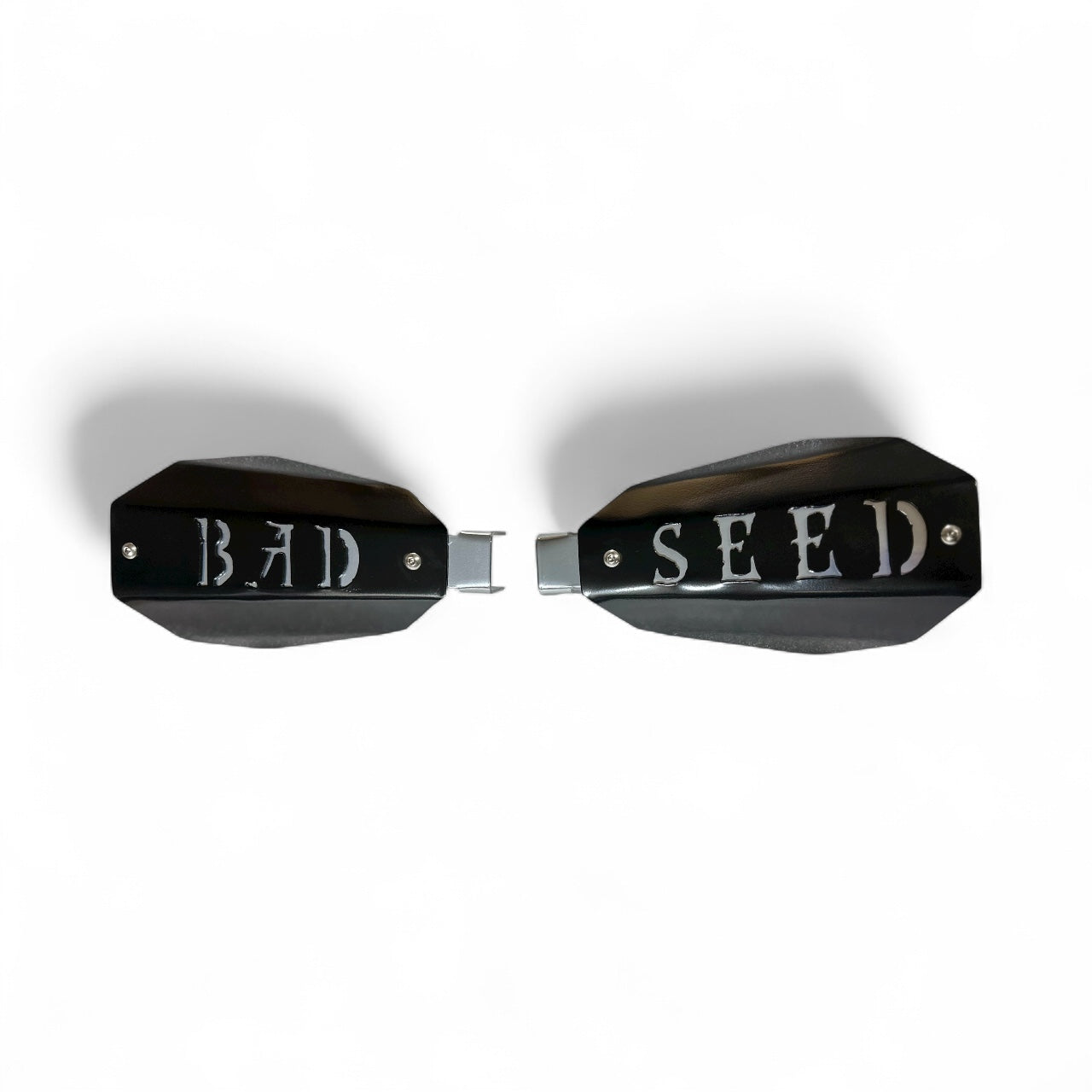 Bad ass mototcycle hand guards with the saying "bad Seed" cut into the black powder-coated outer shell bolted to a chrome powdercoated mount.