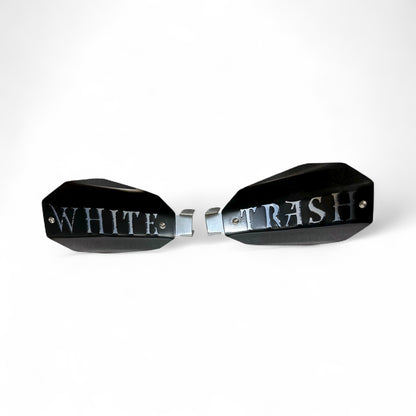 Motorcycle hand guards with the saying "White Trash" cut into the black powder-coated outer shell bolted to a chrome powder coated mount.
